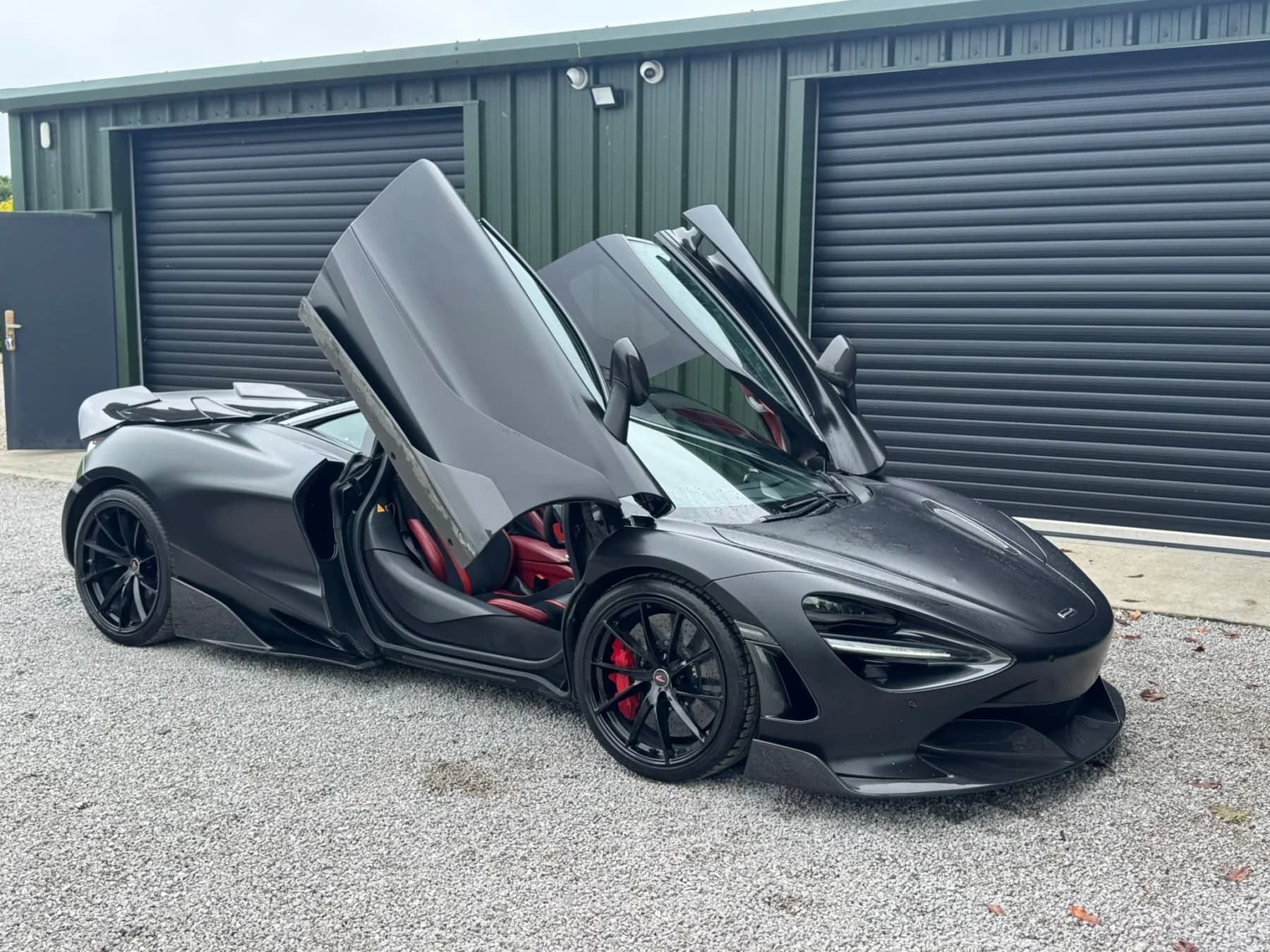 Black McLaren 720S with its dihedral doors open